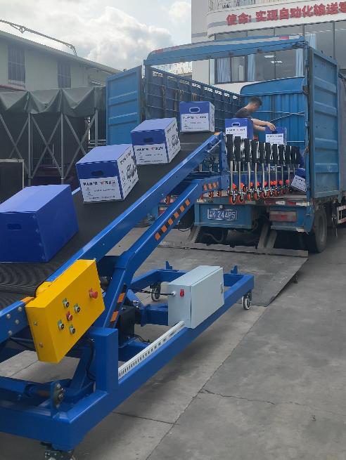 Hydraulic lift and incline conveyor loading a truck from ground level